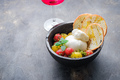 Buratta cheese with cherry tomatoes, basil and olive oil on black plate with crusty bread. Copy - PhotoDune Item for Sale