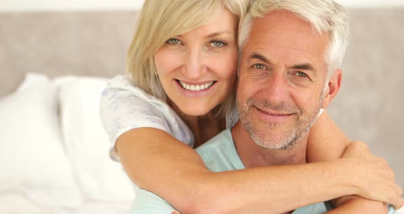 Couple Embracing and Smiling at Camera