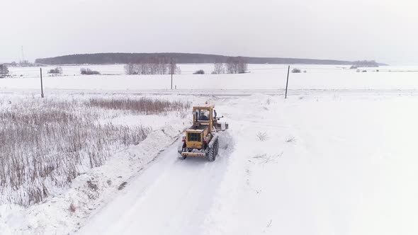 Aerial view of Snowblower Grader Clears Snow Covered Country Road 17