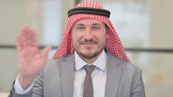 Portrait of Middle Aged Arab Businessman Waving, Welcoming