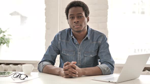 Serious African Man Sitting in Office