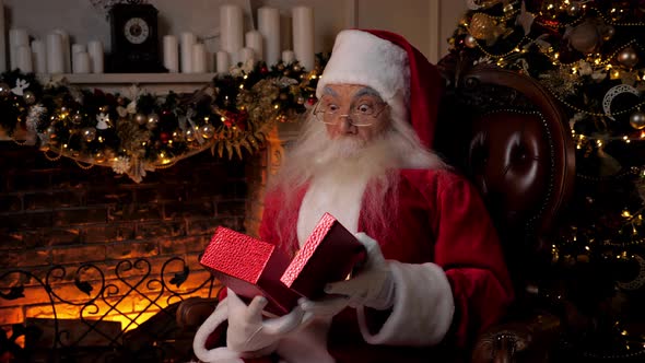 Santa Claus Opens Red Gift Box and is Surprised Christmas Winter Holidays