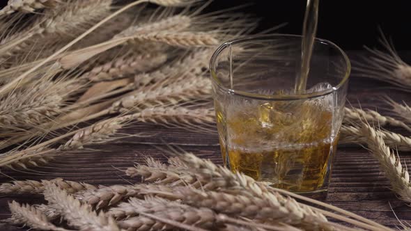 Whisky and Barley. Whisky Is Pouring Into a Glass