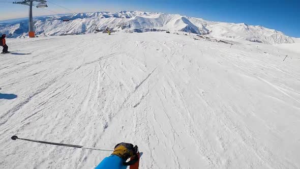 Skier Riding on Slope with Front Holding Camera