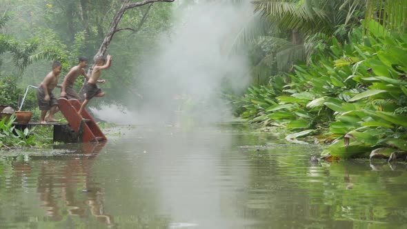 Slow motion of Thai children jumping in canal or river. Happiness young kids. Lifestyle people