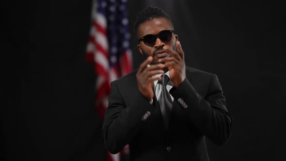 Proud Confident African American Man Putting on Sunglasses Crossing Hands in Camera Flashes As