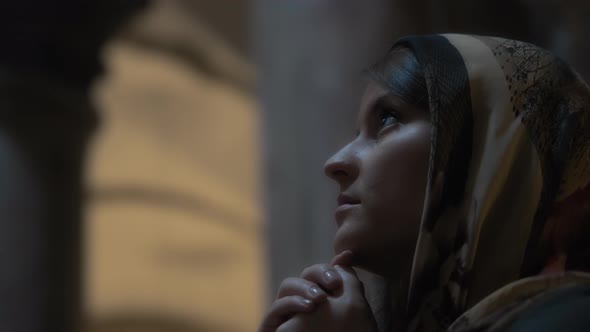 Young religious woman praying