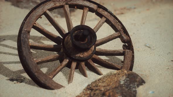 Large Wooden Wheel in the Sand