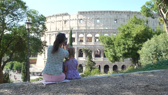 Mother with Daughter Taking Photos of Colosseum