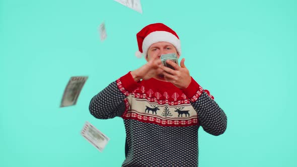 Rich Man Winner in Christmas Red Sweater and Hat Showing Wasting Throwing Money Around Shopping