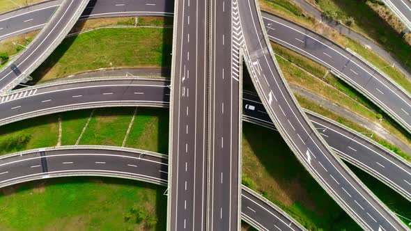 Freeway Road with Moving Cars Between Green Fields