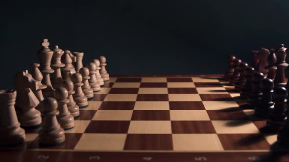 Chess Closeup in dramatic light Wooden Chess Board.