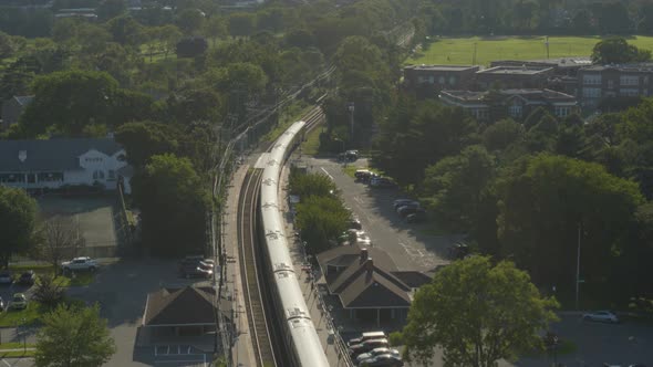 Aerial View of a Train Passing Through Garden City Long Island on a Sunny Day