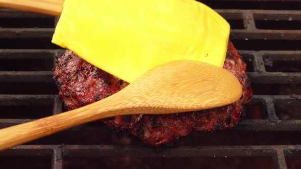 Top View of the Homemade Burger Cutlet with Cheese on the Top on the Grill Grid