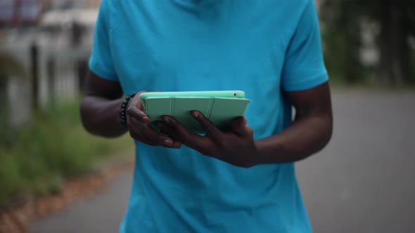 Tablet in Hands of African American Busy Man Scrolling Touchscreen in Slow Motion