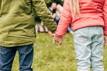 cropped shot of cute little children holding hands outdoors / Photodune, Misc