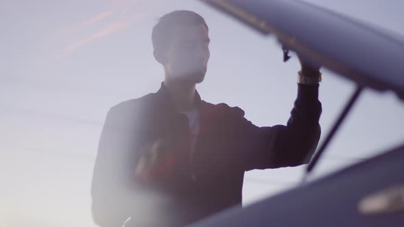 a Young Skinny European Guy Fixes His Car and Closes the Hood