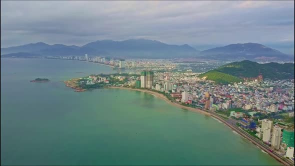 Drone Flies Over Azure Sea Coast with Modern Resort City