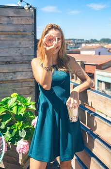 Funny woman posing covering her face with a donut / Photodune, Misc