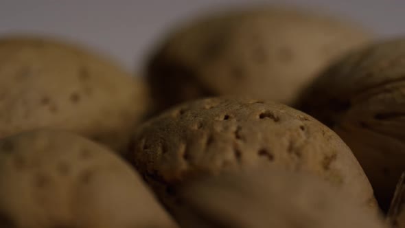 Cinematic, rotating shot of almonds on a white surface 