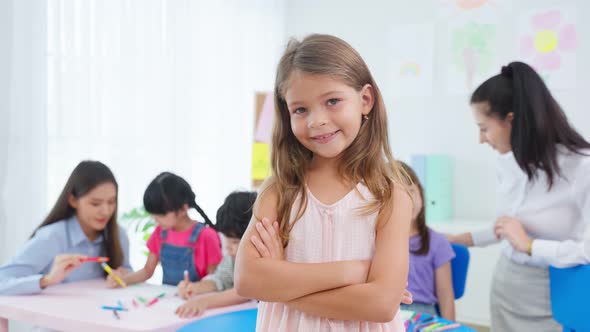 Portrait of Caucasian girl student stand with happiness in class room.