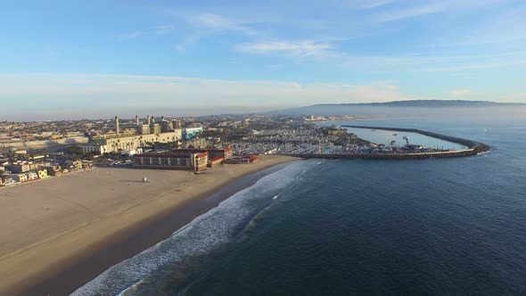 Aerial shot of a scenic beach city and ocean at sunset