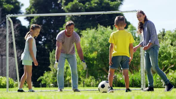 Happy family playing football