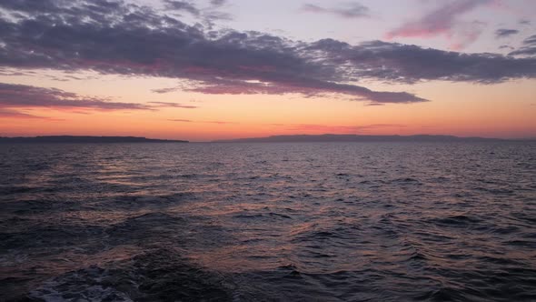 Sun Rises Over Sea Waves at Early Morning