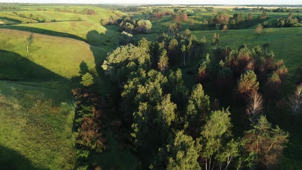 Aerial View of Beautiful Landscape with Hills and Green Field