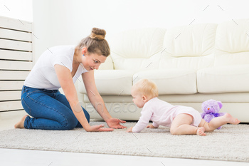 Adorable baby girl learning to crawl in white sunny room / Photodune, Misc