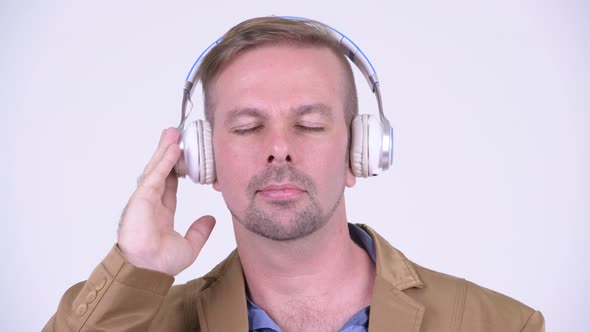 Happy Blonde Casual Businessman Listening To Music