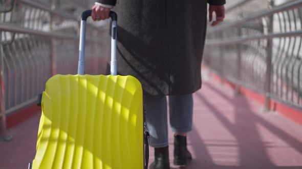 Live Camera Follows Yellow Travel Bag As Unrecognizable Caucasian Young Woman Walking in Slow Motion