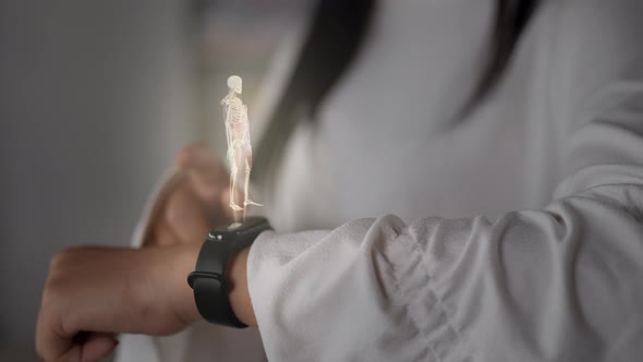 Young woman scanning her health with futuristic smartwatch