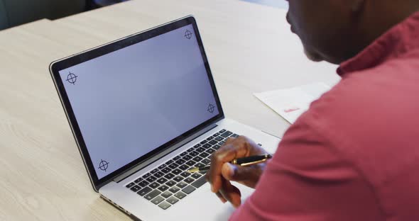 Video of african american man working on laptop with copy space on screen