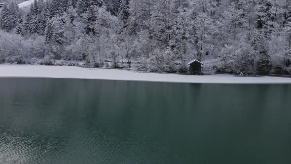 Drone Tracking Shot of Klammsee Reservoir and Winter Forest Scenery Austria