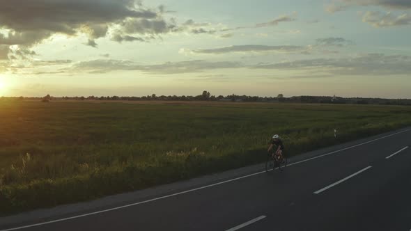 A Cyclist is Riding Fast on the Highway