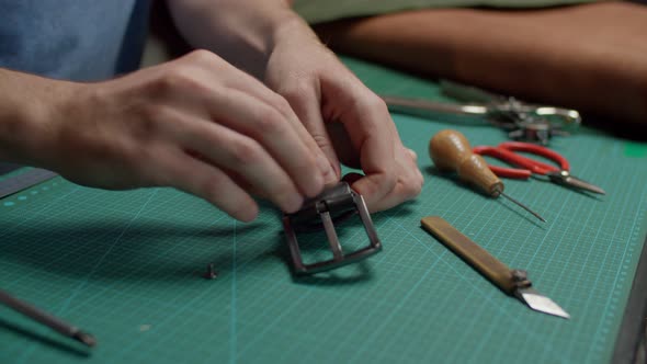 Skilled Worker Preparing Leather Belt for Pruning By Hand in Workshop