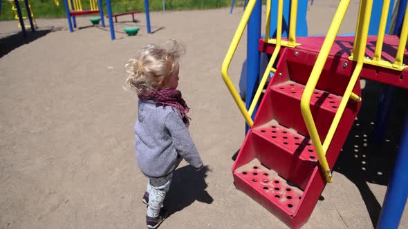 Excited Young Boy on Playground Frame