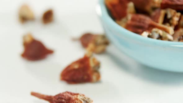 Dried chilies in bowl placed on white surface 4K 4k