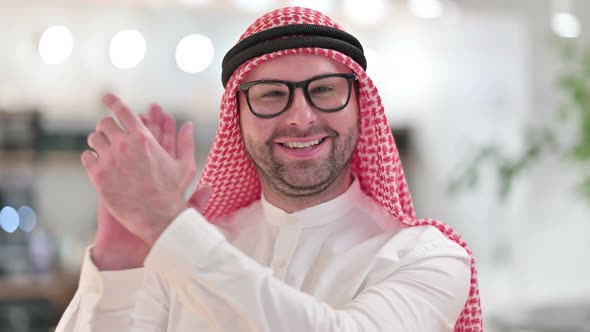Excited Young Arab Businessman Clapping Cheering