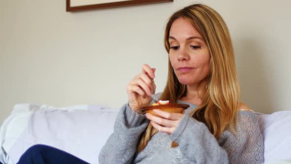 Woman having breakfast in bedroom 4k