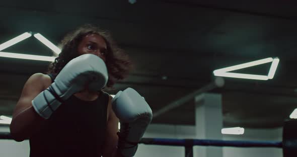 African Pugilist is Training on Boxing Ring Punching Target Pads on Coach Hands Portrait  Prores