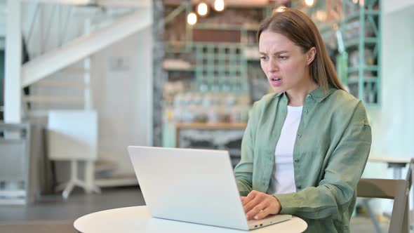 Loss Woman Reacting to Failure on Laptop in Cafe