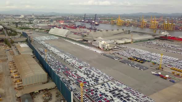 Aerial view of logistics concept of commercial vehicles, cars and pickup trucks waiting to be load o