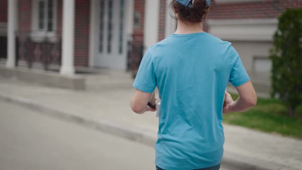 A Young and Energetic Delivery Man Carrying a Pizza and a Bag of Groceries