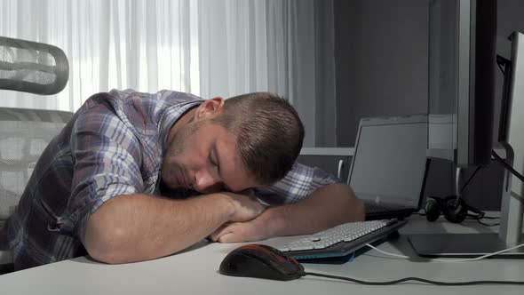 Man Sleeping on His Desk After Finishing Working on the Computer