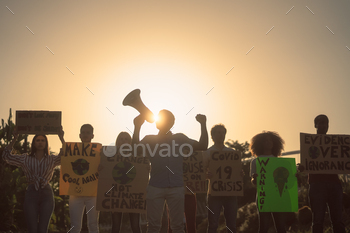 – Multiracial people fighting on road holding banners on environments disasters – Global warming concept