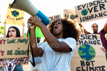 �� Multiracial people fighting on road holding banners on environments disasters – Global warming concept