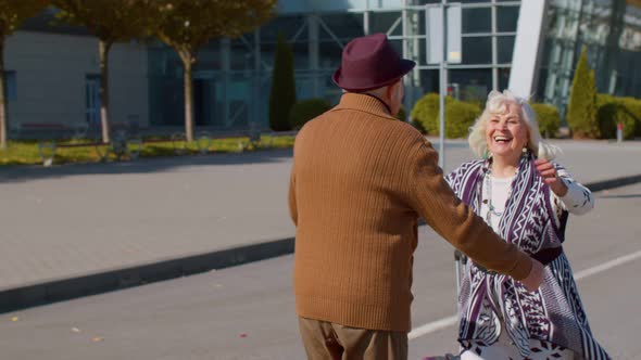 Senior Old Husband and Wife Retirees Tourists Reunion Meeting in Airport Terminal After Traveling