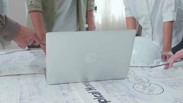 Close Up Of Group Of Asian Engineers Discuss About Work On Laptop At The Office